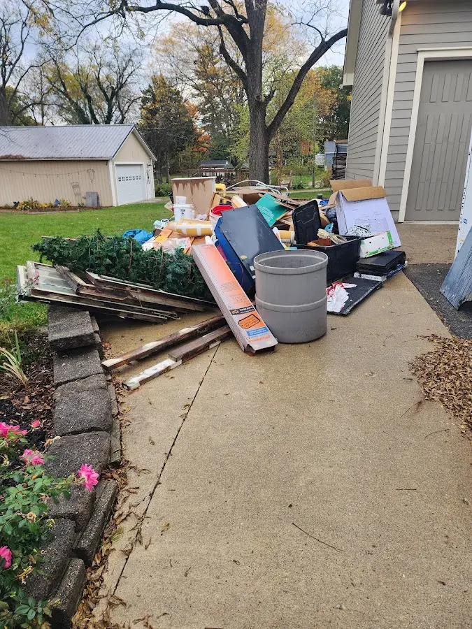 Dumpster being loaded with debris for Roofing Dumpster Rental in Manhattan